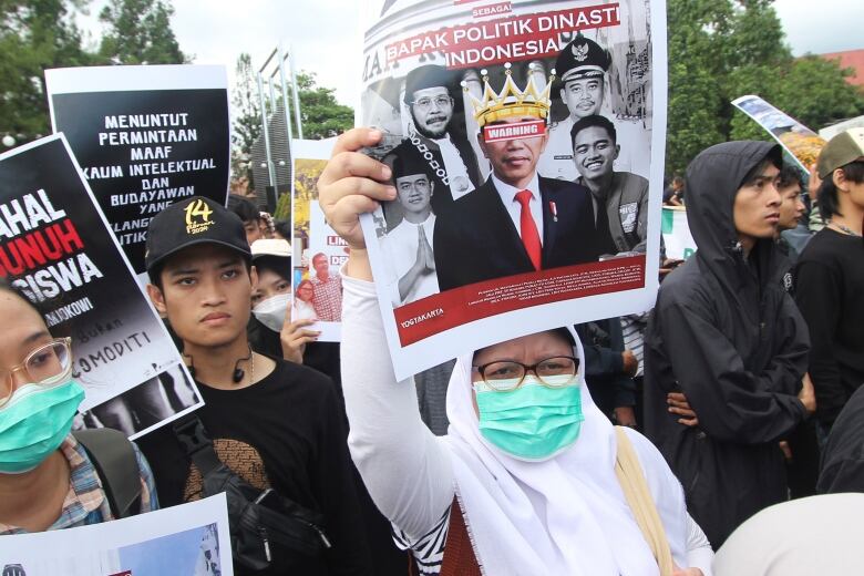 Protestors holding up placards