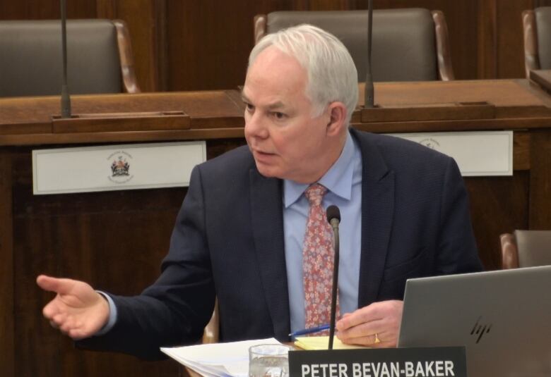 Peter Bevan-Baker gesturing while sitting at a desk.