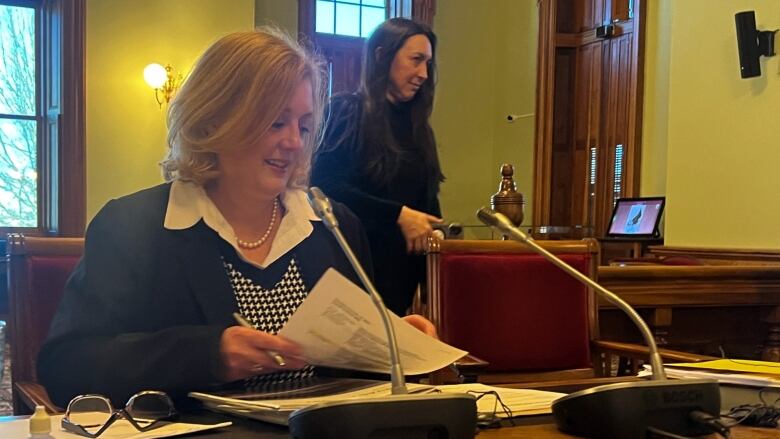 Kimberly Poffenroth sits at a desk