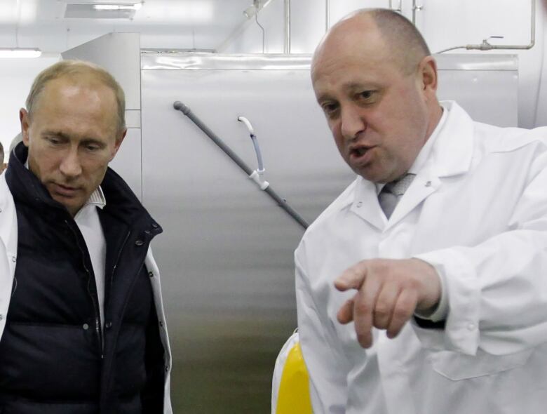 A 2010 photo shows Russia's Vladimir Putin standing alongside Yevgeny Prigozhin.