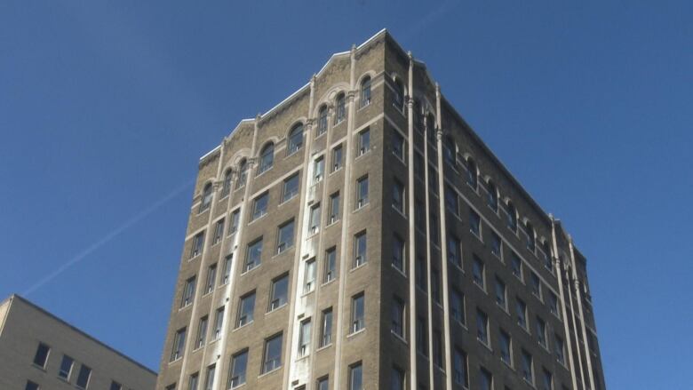 A grey building in a clear blue sky.