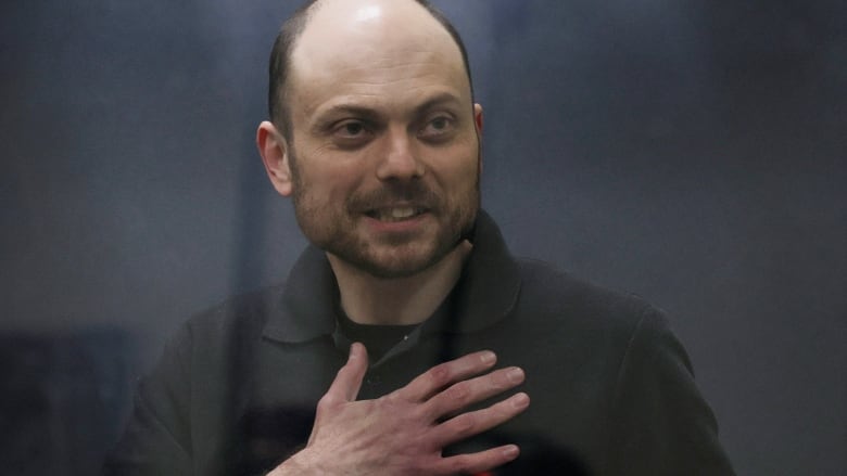 Jailed Russian opposition figure Vladimir Kara-Murza gestures as he stands behind a glass wall of an enclosure for defendants during a court hearing to consider an appeal against his prison sentence, in Moscow, Russia July 31, 2023.