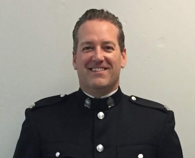 A white man is seen in his Victoria Police department uniform.