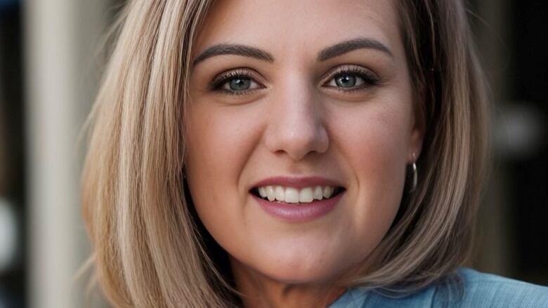 Smiling blonde woman in blue business suit. 