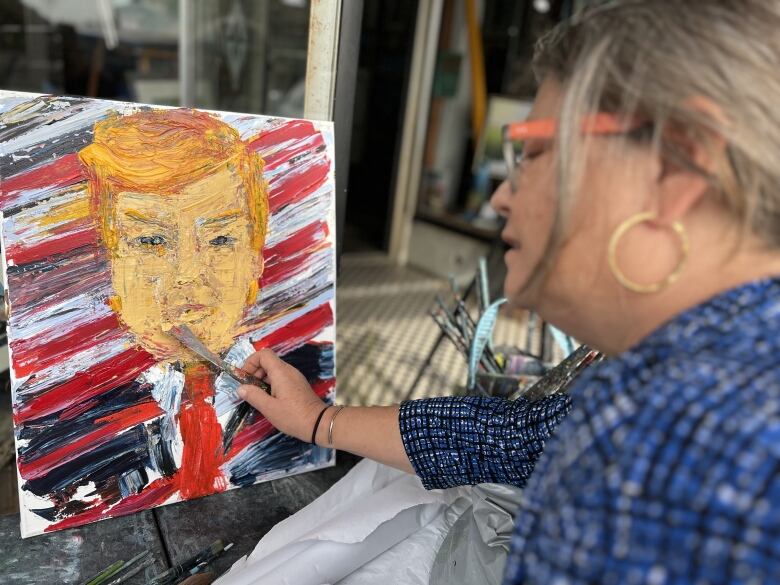 Woman paints a portrait of Trump