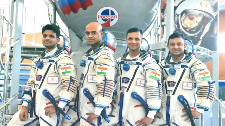 four Indian astronauts in their space suits smiling for a portrait