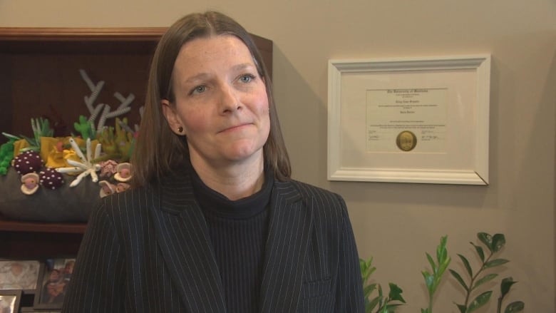 A woman standing in a room at the Manitoba legislative building.