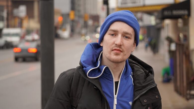 A man on a downtown street in late winter.