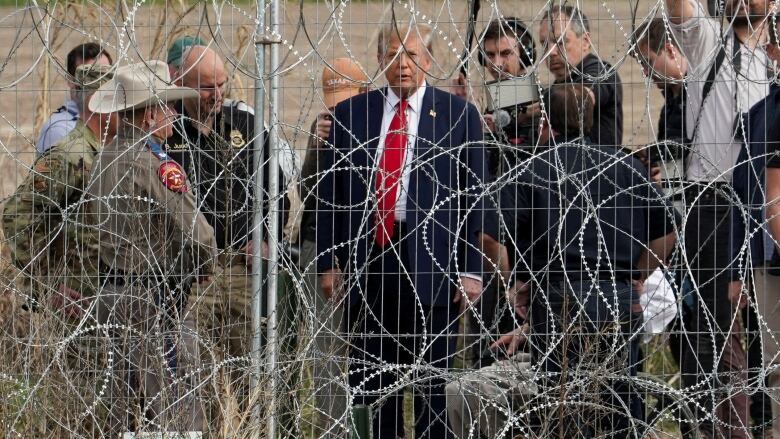 Trump behind razor wire