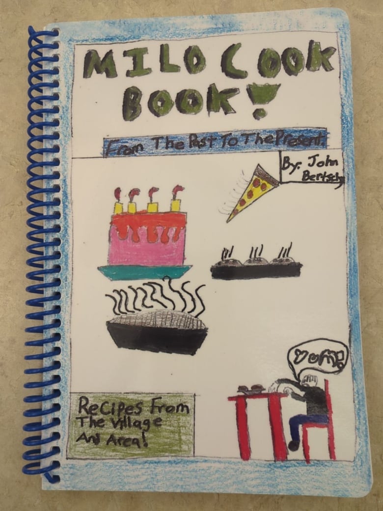 A close-up shot of a cookbook with food-related illustrations.