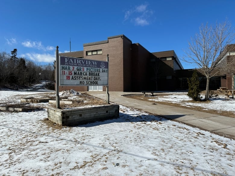 A brown brick building is shown in the background with a sign saying Fairview Junior High School in the foreground.