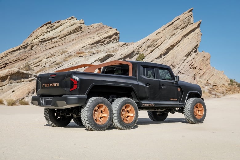 A large black truck with six tires.