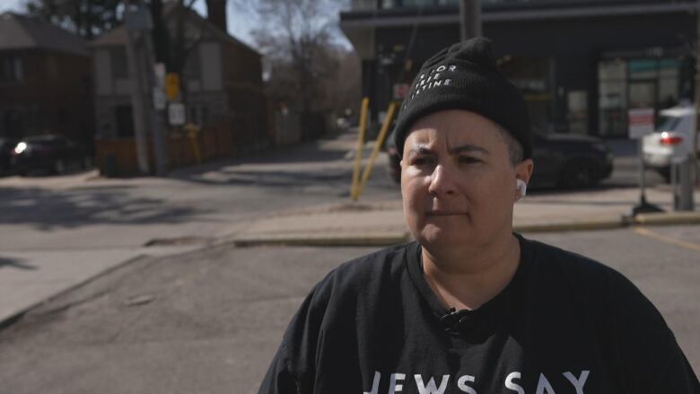 A woman looks past the camera.