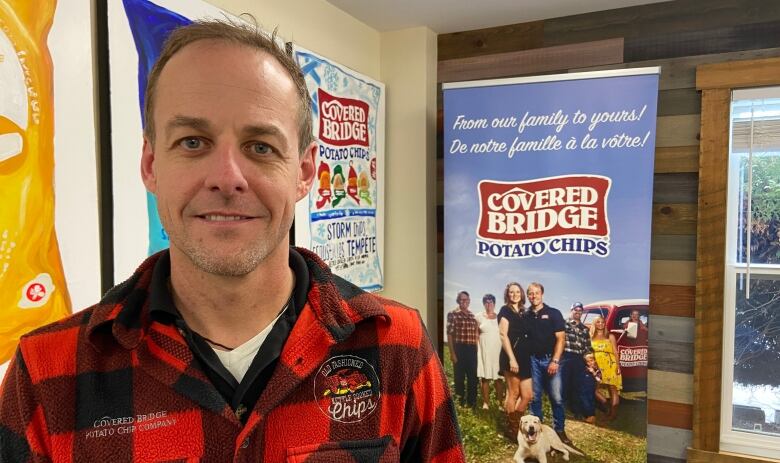 Ryan Albright stands inside the head office for Covered Bridge Potato Chips.