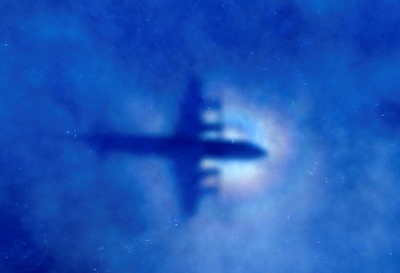 The shadow of a Royal New Zealand Air Force (RNZAF) P3 Orion maritime search aircraft can be seen on low-level clouds as it flies over the southern Indian Ocean looking for missing Malaysian Airlines flight MH370 March 31, 2014.   