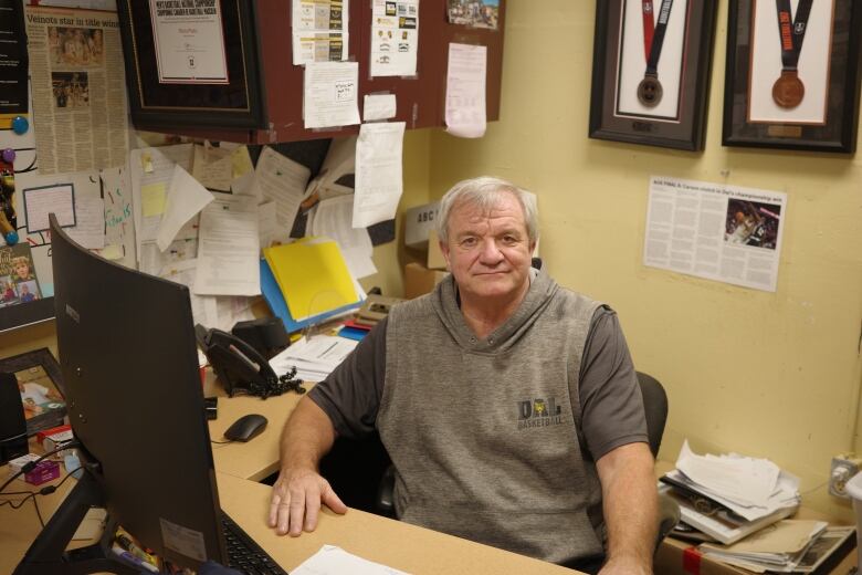 Rick Plato sits behind his desk at the Dalhousie University's athletic centre.