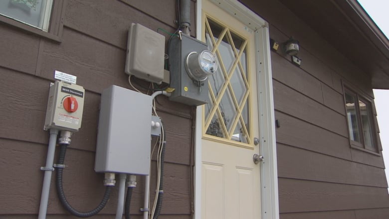 An electricity meter and other apparatus seen outside a home.