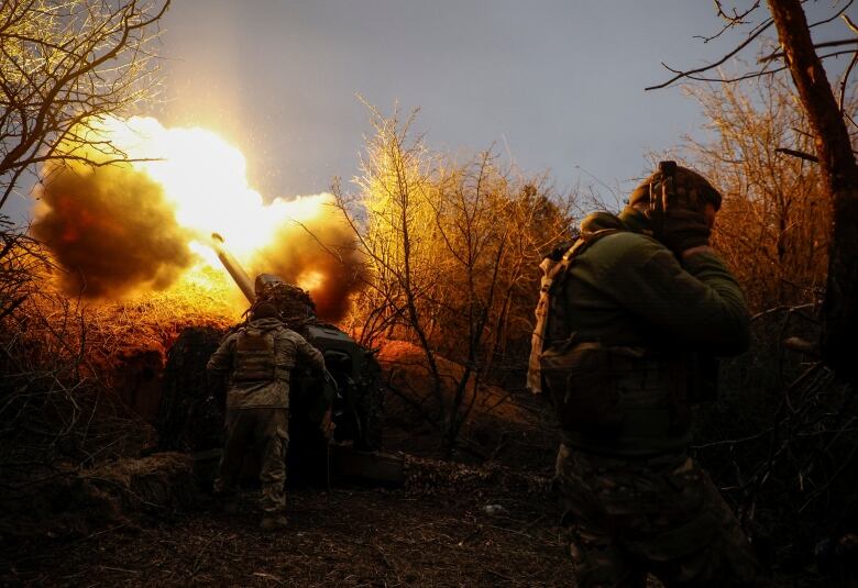 Ukrainian soldier are seen firing a howitzer toward Russian troops, near the front line in the Kherson region.