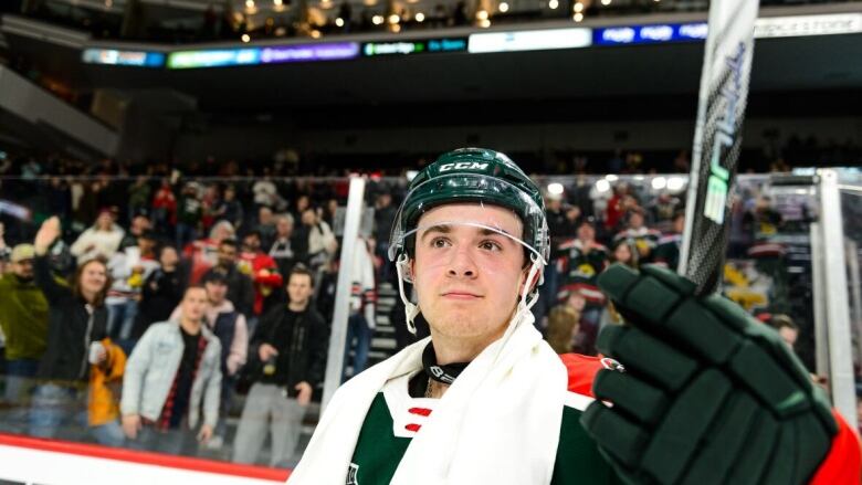 A hockey player smiles