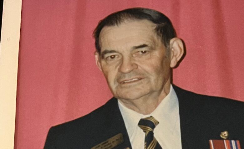 A photo from the 1960's shows a middle aged man in military regalia.