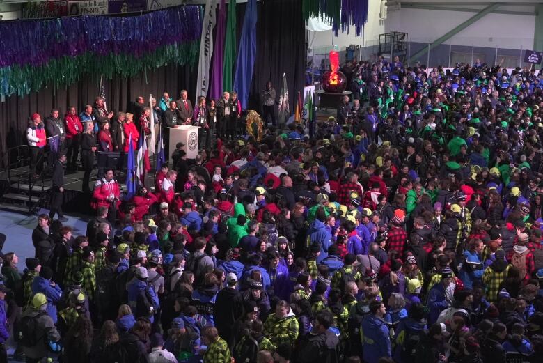 A large crowd gathered in front of a podium