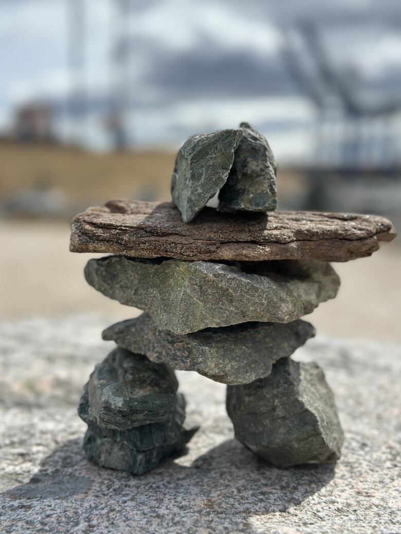 Rocks piled together form an inukshuk. 