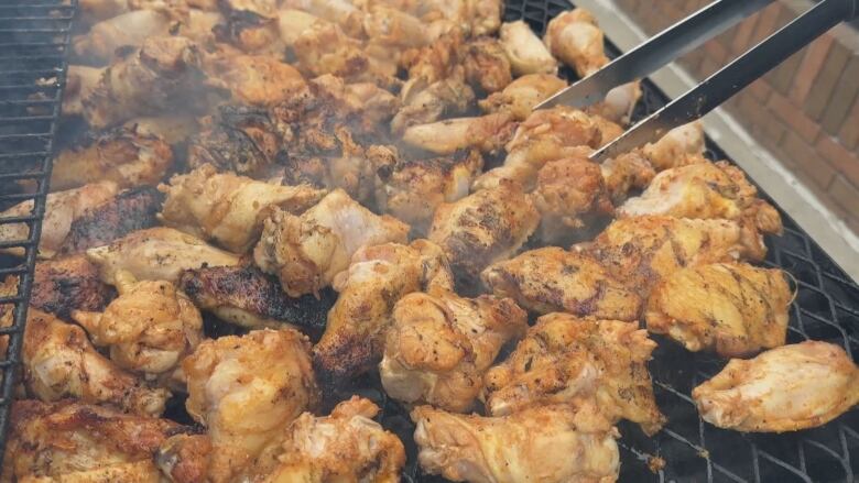 A picture of cooked chicken on a charcoal grill 