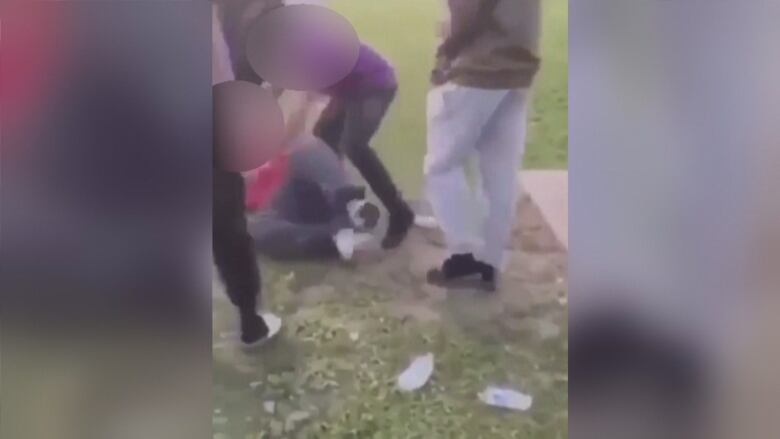 Video captures the beating of a youth by other youths.