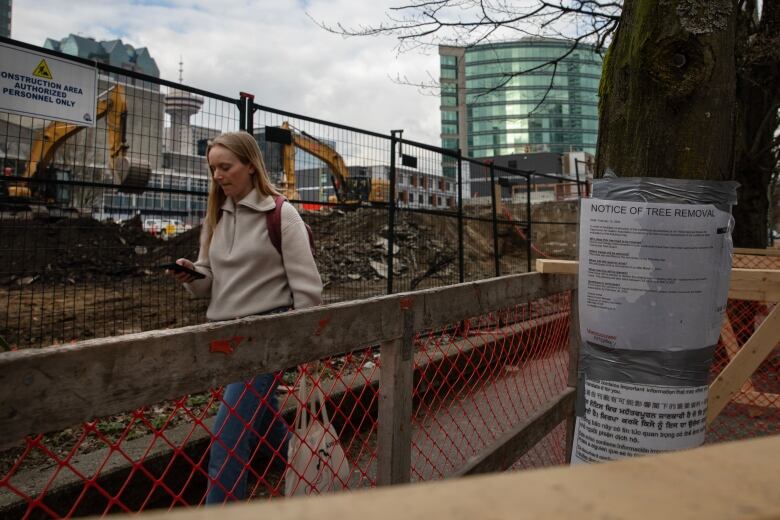 A person walks by Vancouver Art Gallery construction site, pictured on Thursday, March 21, 2024.