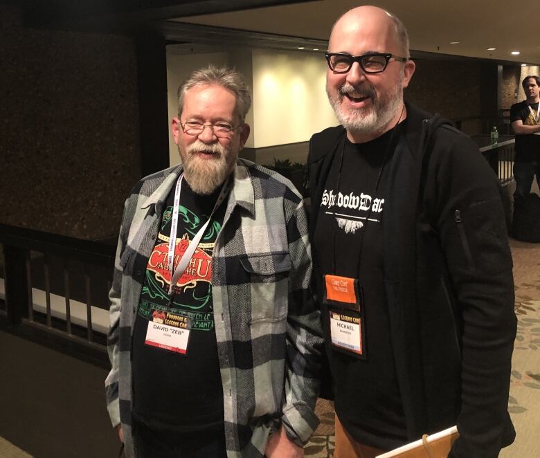 Two men pose together for a photo.