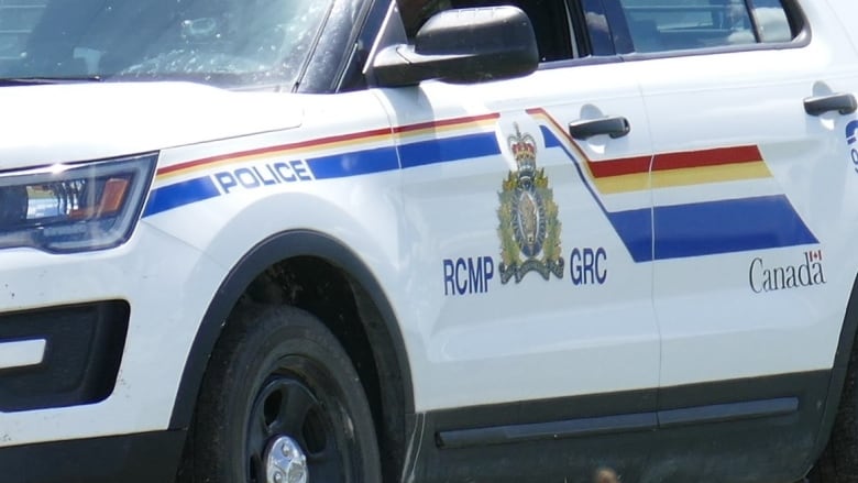 A closeup of the side of an SUV shows the RCMP crest and the words 