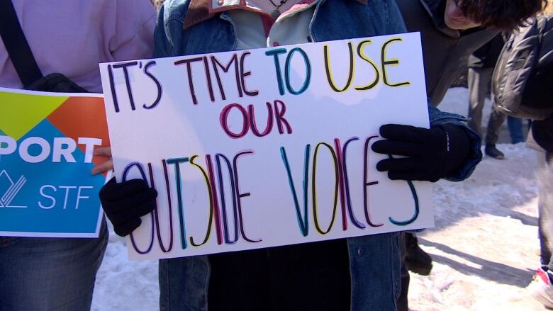 A close-up image of a sign that says 'it's time to use our inside voices.'