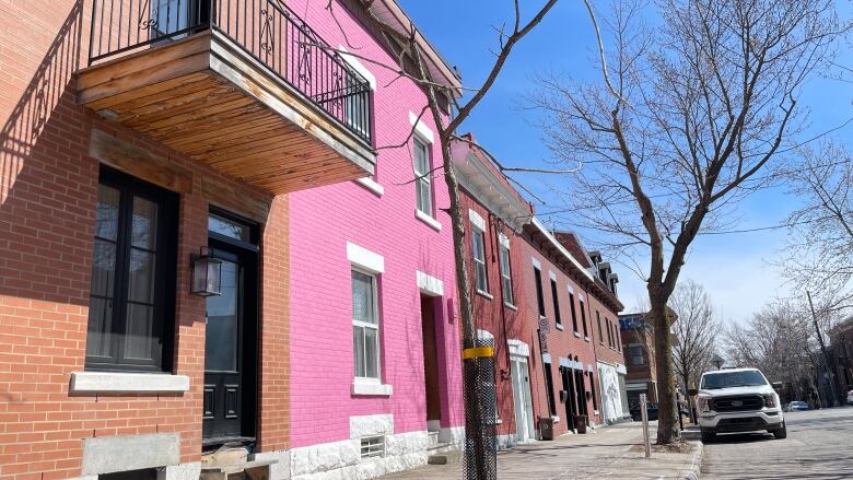 colourful homes stuck together along an urban street.