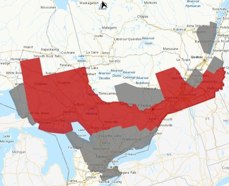 A map of the Great Lakes area with weather warnings on it. A band of red runs through the Ottawa area, with grey around it.