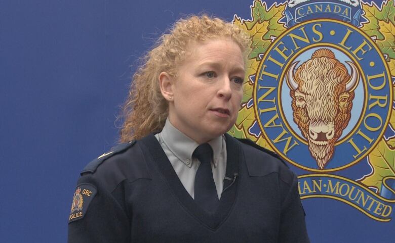 Blonde woman wearing police uniform.