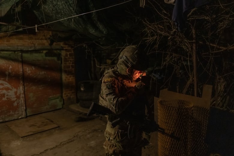 A 40-year-old Ukrainian soldier is seen having a smoke in an area near the town of Chasiv Yar, in Ukraine's Donetsk region.