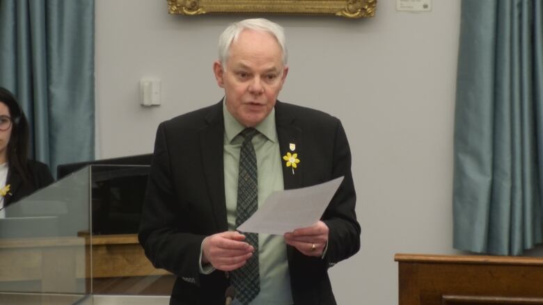 Peter Bevan-Baker standing with a paper in his hands in the PEI Legislature