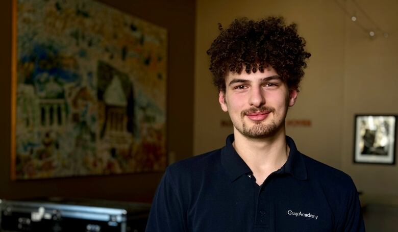 A young man wearing a polo.