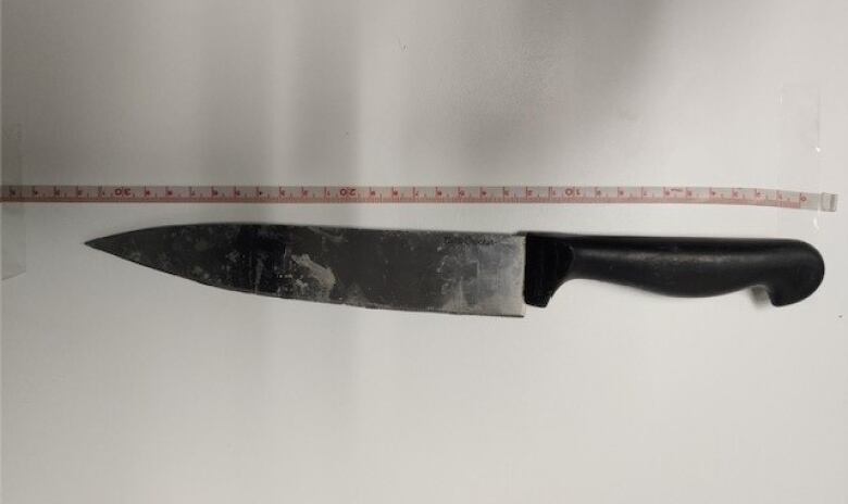 A knife parallel to measuring tape.