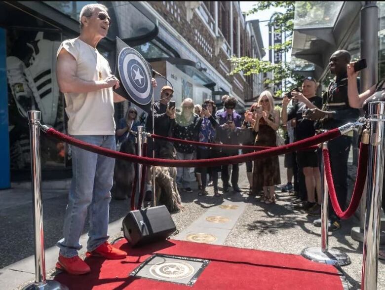 Vancouver musician Rocket Norton at the Granville Street's walk of fame during an induction ceremony last year amidst crowd of people. 