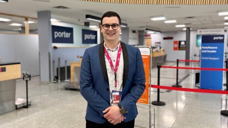 A smiling man at an airport.