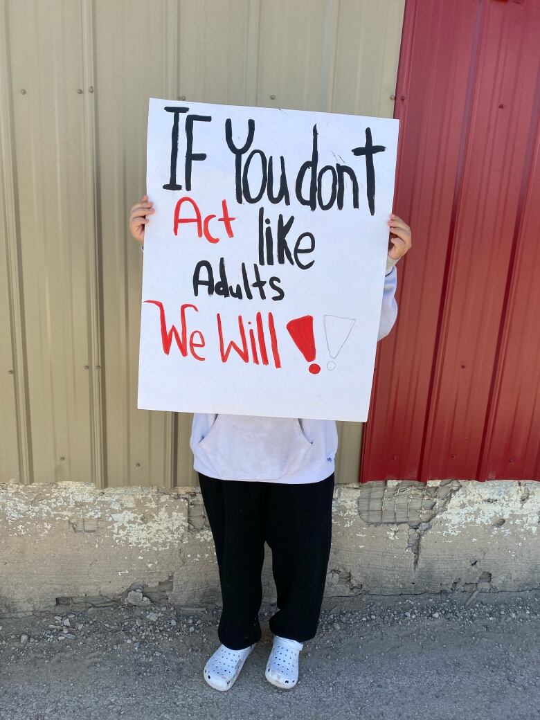 a person holding up a sign in protest. 