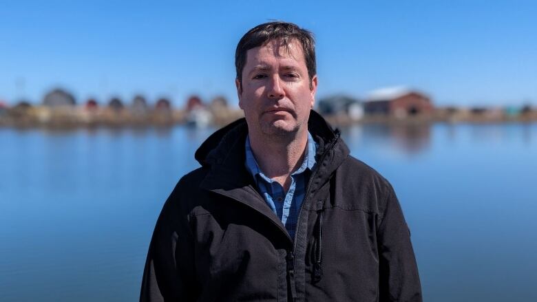 A fisherman stands on a wharf 