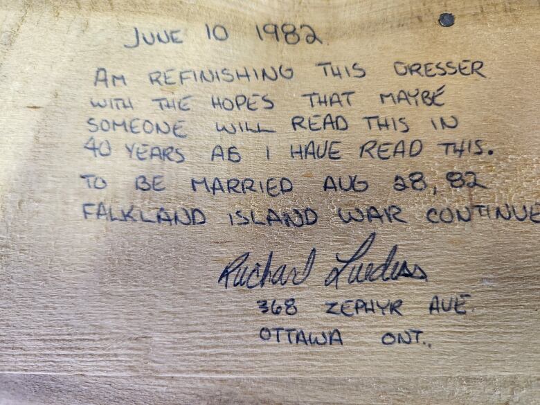 Handwritten note on a dresser