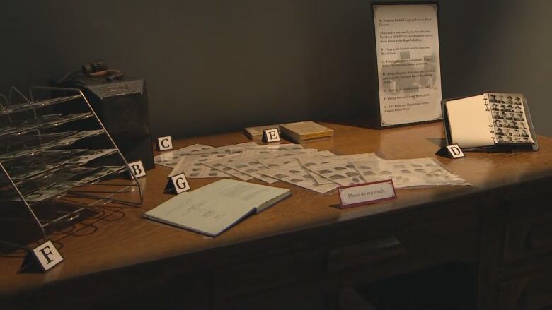 a museum table with artifacts. a sign reads 