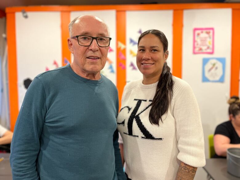 Chelsea Phillips and Richard Nolan standing next to each other in a craft room.