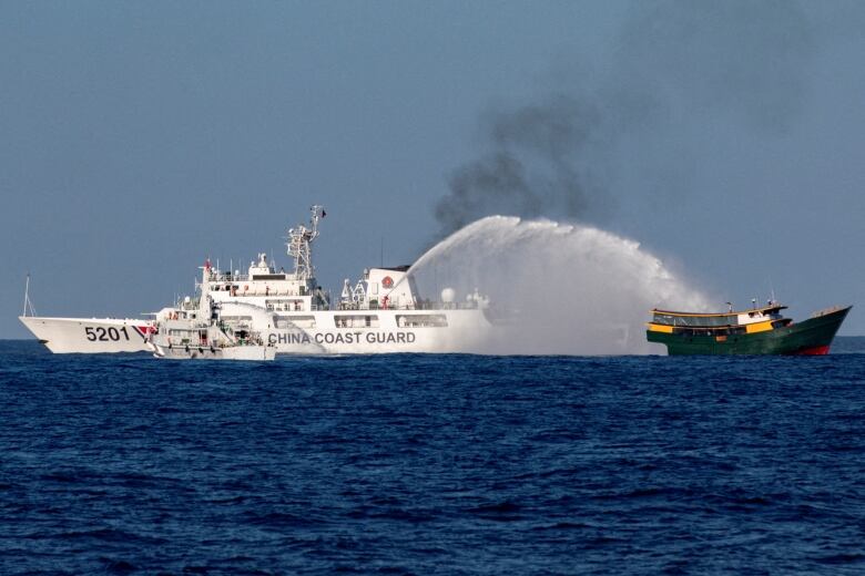 Chinese Coast Guard vessels firing water cannons at a Philippine resupply vessel last month in the South China Sea. 