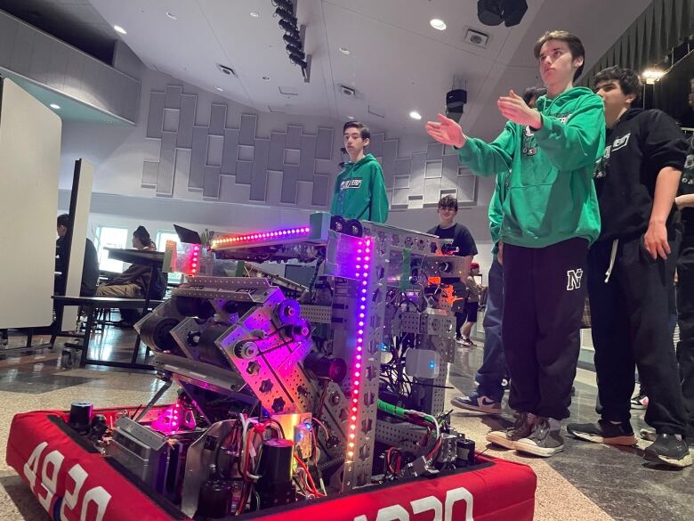 Member of the Belle River Boltheads work with a robot they built.