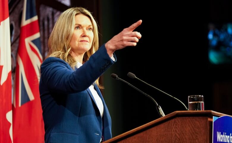 Jill Dunlop points during a press conference. 