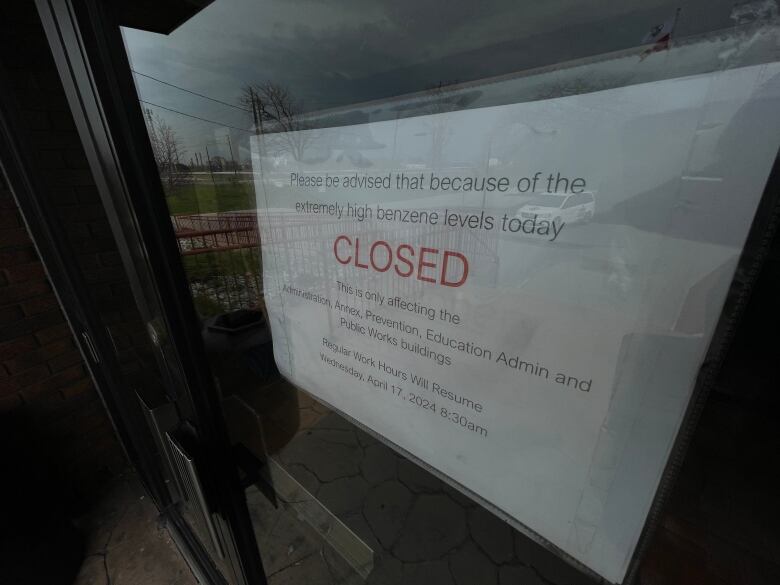 A sign says that Aamjiwnaang First Nation buildings are closed due to high benzene levels. 